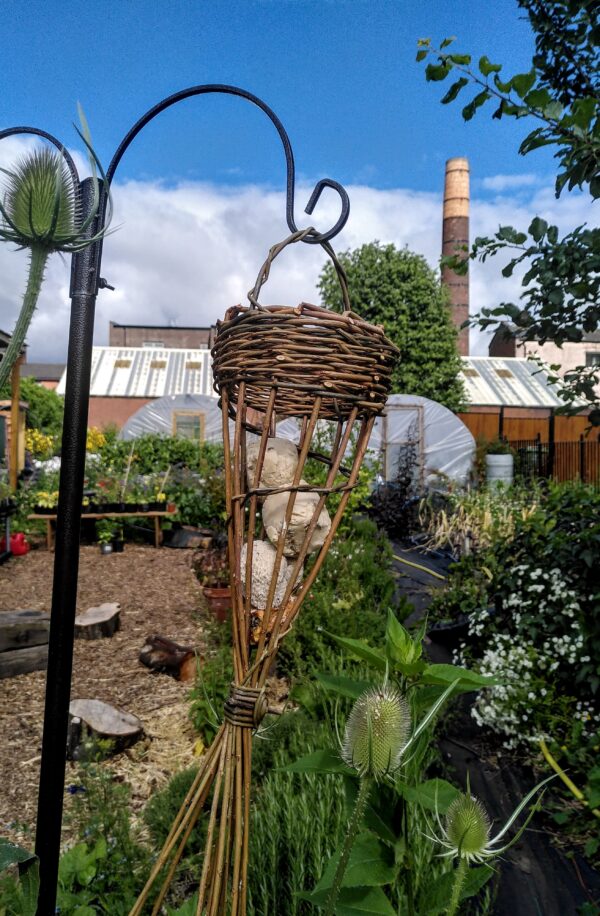 A hanging willow bird feeder.