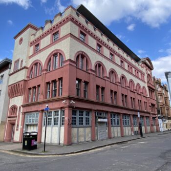 Photograph of a polychromatic building against a blue sky