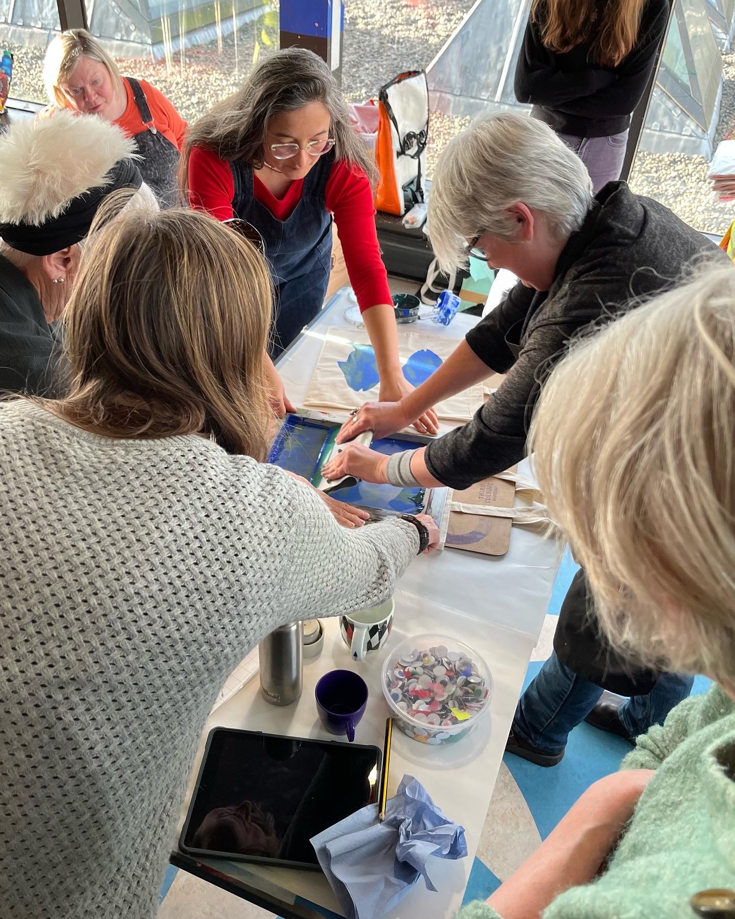 A group of people screen printing